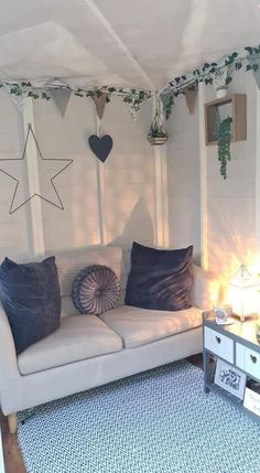 a living room with white couches and pillows