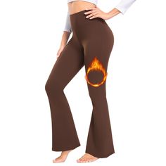 a woman in brown flarer pants with flames on the side and her stomach showing