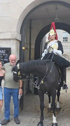 a man riding on the back of a black horse