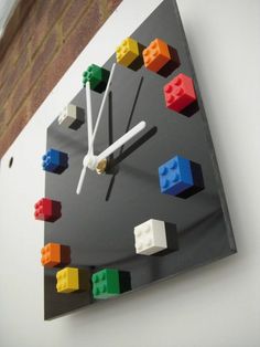 a clock made out of legos on the wall