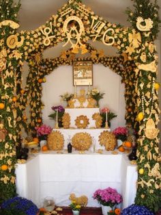 an elaborately decorated altar with flowers and decorations