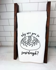 a dish towel with the words, why are you? on it in black ink