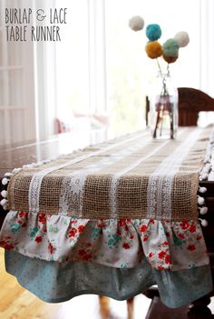 the table is covered with an old - fashioned linen and has red flowers on it