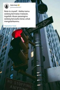 a red traffic light sitting next to a tall building