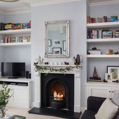 a living room filled with furniture and a fire place