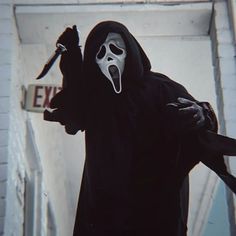 a person in a ghost costume holding a knife