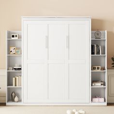 a white bookcase with doors and shelves in a room that has carpeted flooring