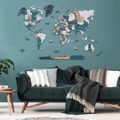 a living room with a green couch and a map on the wall above it,