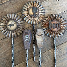 three decorative metal items on a wooden floor