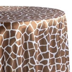 a giraffe print table cloth on top of a round table with a white background