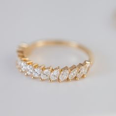 a gold ring with five pear shaped diamonds