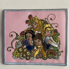 this is an image of a pink patch with princesses and flowers in the center