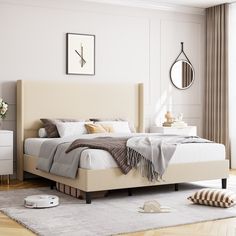 a bedroom with white walls and wooden floors