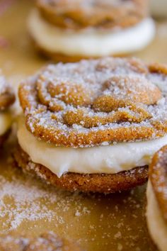 some cookies with icing and powdered sugar on them are sitting on a table