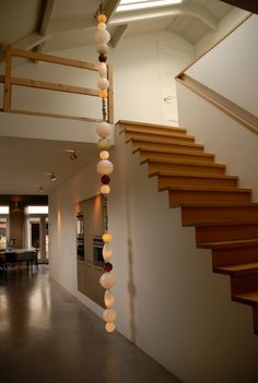 a staircase with lights hanging from it's sides