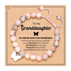 a bracelet with a butterfly charm on it and an inscription that says, to my granddaughter