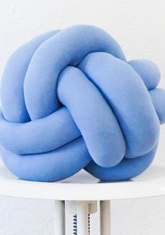 a blue knot sitting on top of a white table