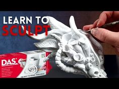 a hand holding a toothbrush in front of a white sculpture with the words learn to sculpt on it