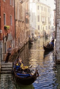 two gondolas are tied to the side of buildings