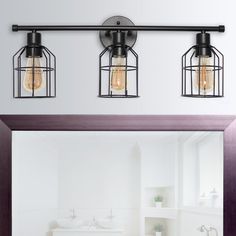 three light bathroom fixture with caged glass shades on the ceiling and mirror in front of it