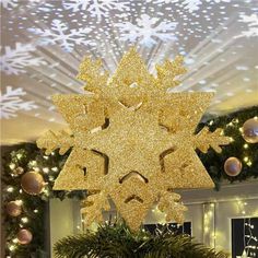 a large gold snowflake sitting in the middle of a room filled with christmas decorations