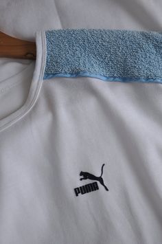 Vintage white and baby blue PUMA sports top, from the 1980s Summer 80s PUMA top with dolman short sleeves and long straight shape. The top features light blue terry cloth pieces on the shoulders, the rest is white! Has the brand's logo on the front Material - cotton and polyester, fabric is thick, not lightweight! Size - L Measurements (taken while top is lying flat, double armpit to armpit): Shoulders (undefined), measured from one sleeve's end to the other - 28.5 inches / 72.4 cm Armpit to Arm 90s Sports T-shirt For Summer, 90s Blue Sports Top, White 90s Style Crew Neck Top, White Sporty Top For Summer, Sporty White Top For Summer, White Retro Sports T-shirt, Retro White Sports T-shirt, 90s Summer Sports T-shirt, White Cotton Athleisure Tops