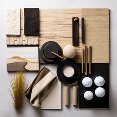 an assortment of different items displayed on top of a white surface with bamboo sticks and chopsticks