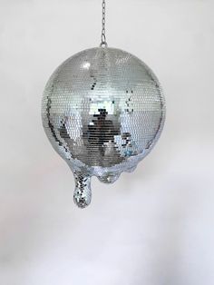 a silver disco ball hanging from a chain