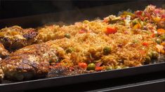 meat and vegetables cooking on an outdoor grill