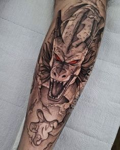 a man's leg with a tattoo on it and a dragon head in the middle