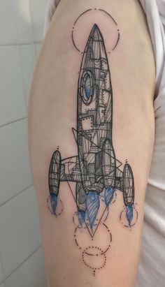 a woman's arm with a drawing of a rocket ship on the left side