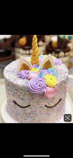 there is a unicorn cake with sprinkles on it