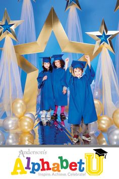 two children in graduation caps and gowns are posing for a photo with gold stars