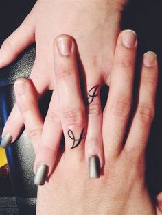 two people with matching rings on their fingers, one has a small bow and the other has an arrow