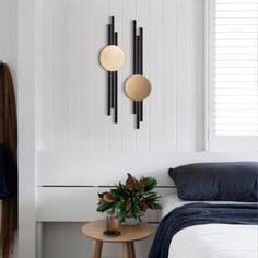 a bedroom with white walls and black accents