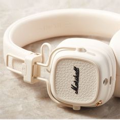 the headphones are white and have black writing on them