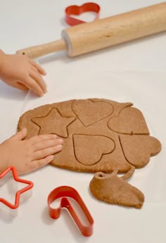 there are some cookies and cookie cutters on the table with doughnut holes in them