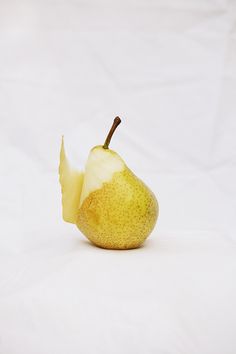 an apple with a bite taken out of it sitting on a white tablecloth background