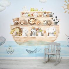 a child's room with an animal themed wall mural and rocking chair in the foreground