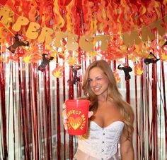 a woman in a corset holding a red cup with the word fecq on it