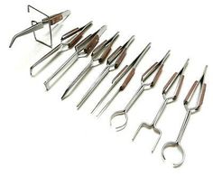 a bunch of tools are lined up on a white surface, including scissors and pliers