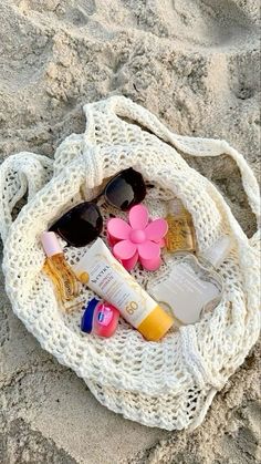 the beach bag is filled with sunscreens and other personal care items on it