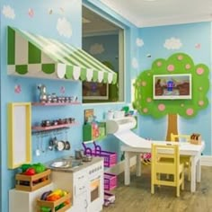 a child's playroom with blue walls and wooden floors