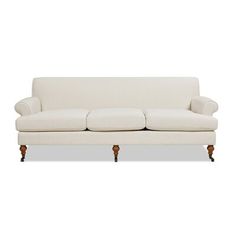 a white couch sitting on top of a wooden frame