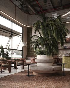 a large potted plant sitting in the middle of a room with tables and chairs