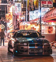 a car parked on the side of a street at night