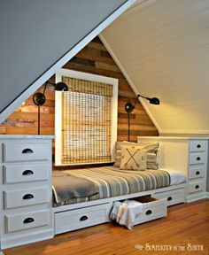 an attic bedroom with drawers under the bed