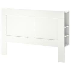 a white headboard with two open shelves on each side and one closed drawer at the top