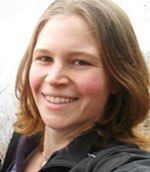 a woman with long hair smiling for the camera