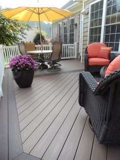 a deck with chairs and an umbrella on it